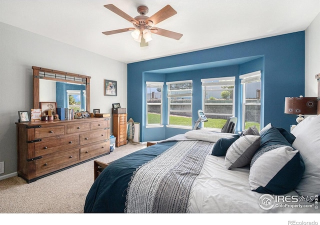 bedroom featuring carpet floors, a ceiling fan, and baseboards