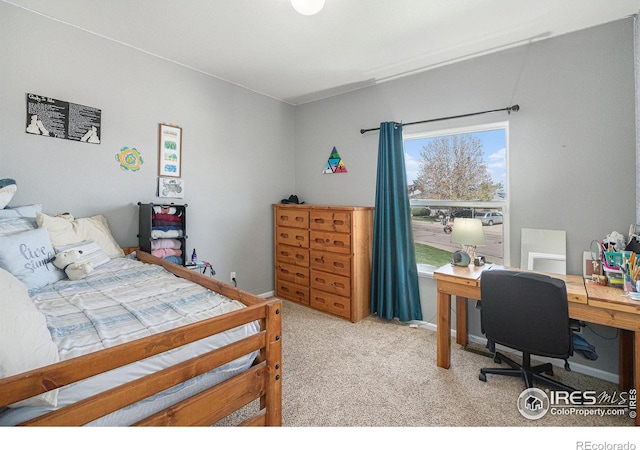 bedroom featuring light carpet