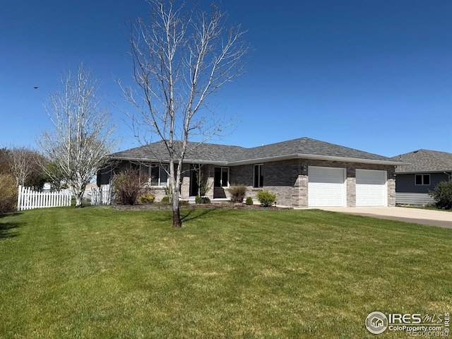 714 S Wynona Ave, Holyoke, CO 80734 - view of front of home featuring fence, an attached garage, concrete driveway, and a front yard
