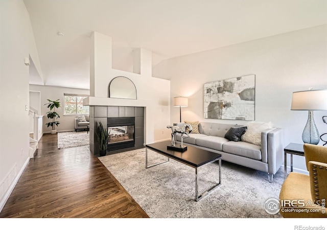 1507 Begonia Way, Superior, CO 80027 - living room featuring wood finished floors, lofted ceiling, baseboards, and a fireplace