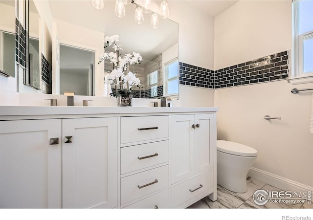 1507 Begonia Way, Superior, CO 80027 - full bath with marble look tile flooring, toilet, double vanity, and baseboards