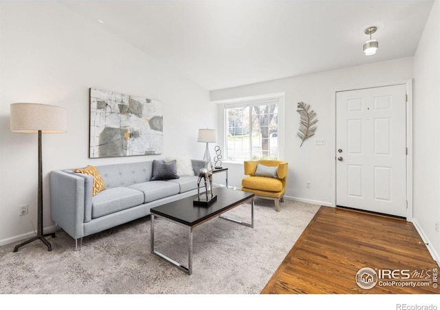 1507 Begonia Way, Superior, CO 80027 - living area with vaulted ceiling, baseboards, and wood finished floors