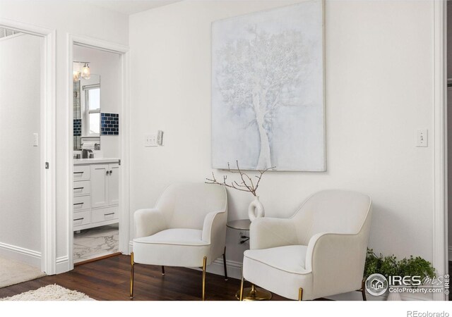 1507 Begonia Way, Superior, CO 80027 - sitting room featuring a chandelier, dark wood-type flooring, and baseboards