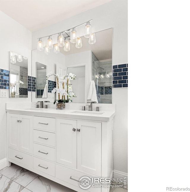 1507 Begonia Way, Superior, CO 80027 - full bathroom featuring a sink, double vanity, marble finish floor, and a tile shower