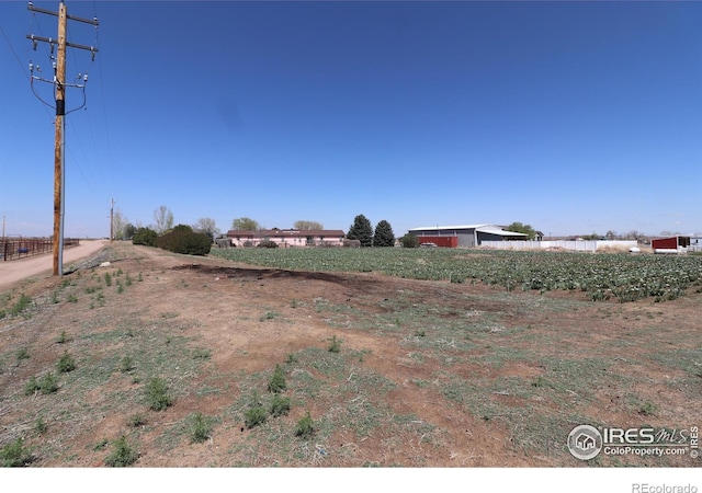 view of yard with a rural view