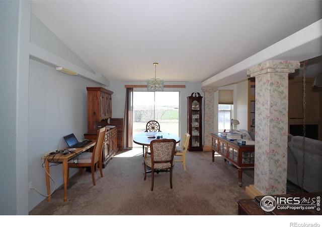 dining room with carpet, lofted ceiling, and a notable chandelier