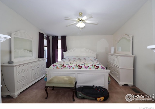 carpeted bedroom featuring a ceiling fan and visible vents