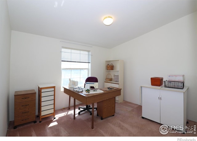 home office with lofted ceiling and light carpet
