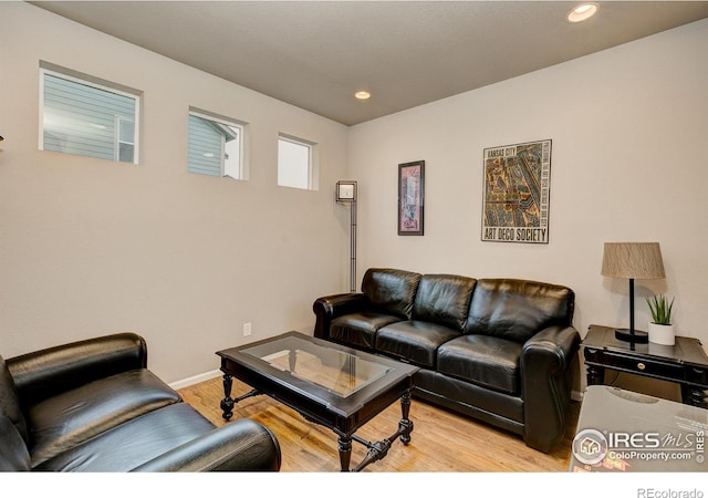 living area featuring recessed lighting, light wood-style flooring, and baseboards