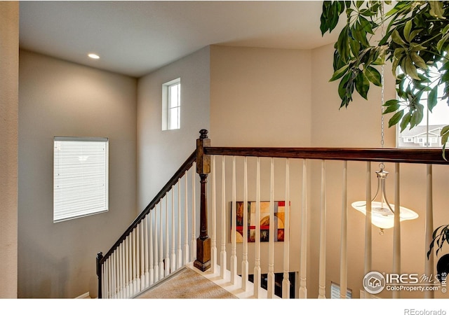 stairs with carpet flooring and recessed lighting