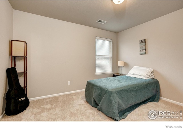 carpeted bedroom with baseboards and visible vents