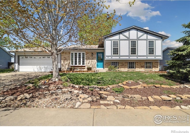 1309 Alexandria St, Lafayette, CO 80026 - view of front facade featuring driveway, brick siding, a garage, and stucco siding