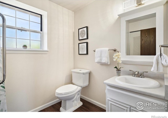 1309 Alexandria St, Lafayette, CO 80026 - full bath with baseboards, wood finished floors, toilet, and vanity