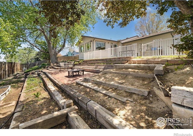 1309 Alexandria St, Lafayette, CO 80026 - back of house featuring a fire pit and a patio
