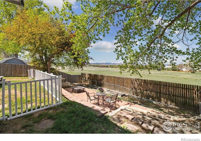 1309 Alexandria St, Lafayette, CO 80026 - fenced backyard with a fire pit and a patio