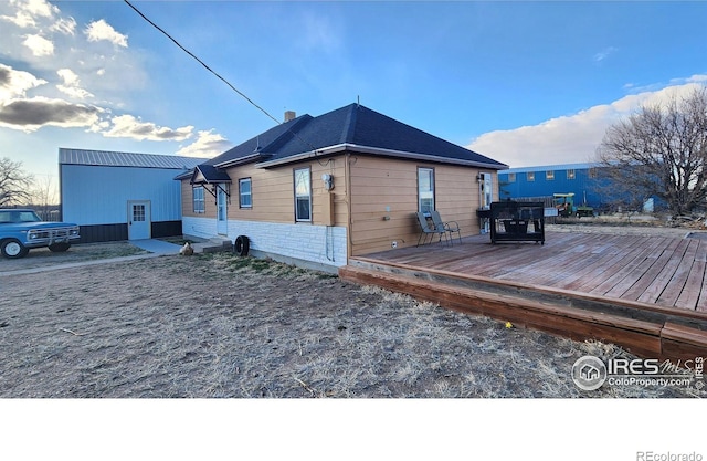 17233 County Road 16, Atwood, CO 80722 - exterior space with a wooden deck and a chimney