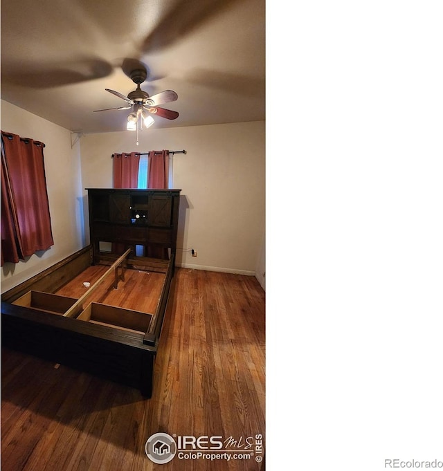17233 County Road 16, Atwood, CO 80722 - bedroom featuring baseboards and wood finished floors
