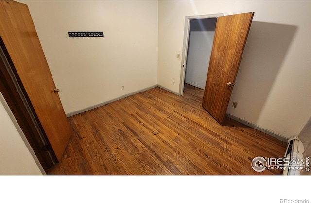 17233 County Road 16, Atwood, CO 80722 - unfurnished bedroom with baseboards and wood finished floors