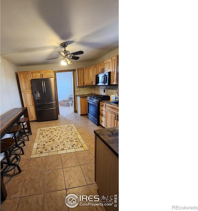 17233 County Road 16, Atwood, CO 80722 - kitchen with ceiling fan, backsplash, dark countertops, light tile patterned floors, and black appliances