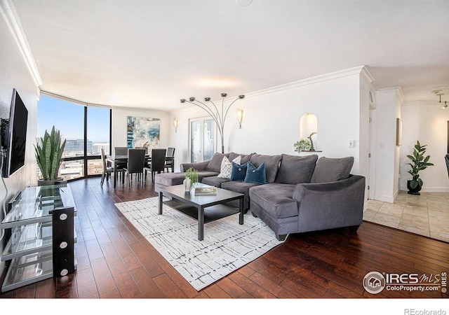 living room featuring crown molding, a wealth of natural light, and hardwood / wood-style floors