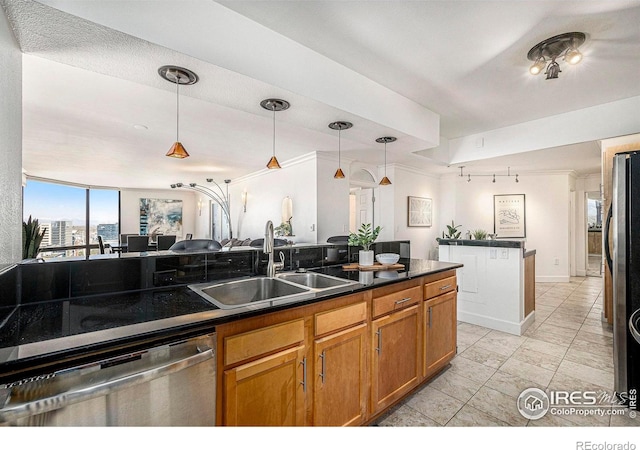kitchen featuring a sink, dark countertops, pendant lighting, and stainless steel appliances