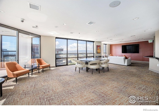 dining area with visible vents, carpet flooring, and floor to ceiling windows