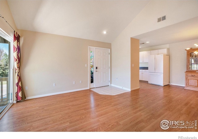 5225 White Willow Dr Unit 210, Fort Collins, CO 80528 - unfurnished living room featuring visible vents, baseboards, high vaulted ceiling, light wood-type flooring, and recessed lighting