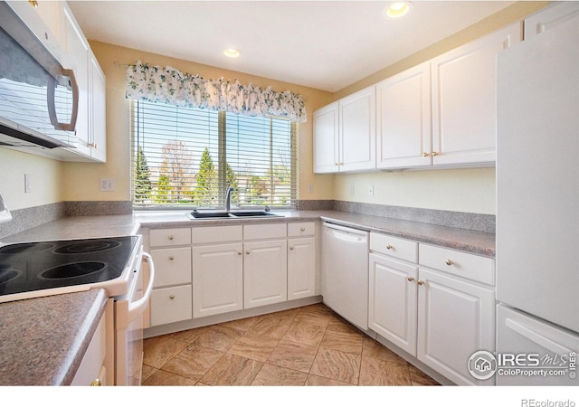 5225 White Willow Dr Unit 210, Fort Collins, CO 80528 - kitchen featuring white appliances, recessed lighting, white cabinetry, and a sink
