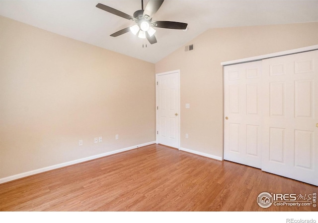 5225 White Willow Dr Unit 210, Fort Collins, CO 80528 - unfurnished bedroom featuring visible vents, a closet, lofted ceiling, light wood-style floors, and baseboards