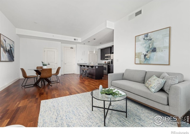 2001 Lincoln St Unit 2113, Denver, CO 80202 - living area featuring dark wood-style floors and baseboards
