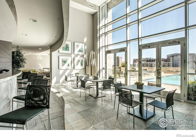 2001 Lincoln St Unit 2113, Denver, CO 80202 - dining room with healthy amount of natural light, french doors, a high ceiling, a city view, and recessed lighting