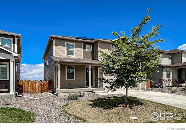 2325 Mountain Sky Dr, Fort Lupton, CO 80621 - view of front of property featuring covered porch, solar panels, and driveway