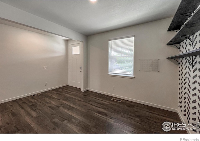 2325 Mountain Sky Dr, Fort Lupton, CO 80621 - foyer with dark wood-style floors and baseboards