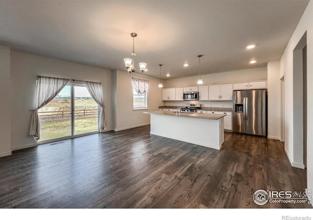 2325 Mountain Sky Dr, Fort Lupton, CO 80621 - kitchen featuring appliances with stainless steel finishes, dark wood-type flooring, white cabinetry, baseboards, and recessed lighting