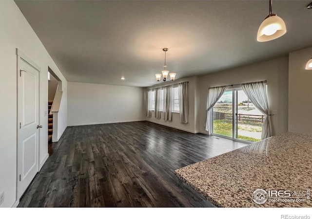 2325 Mountain Sky Dr, Fort Lupton, CO 80621 - unfurnished dining area with dark wood-style flooring, a chandelier, and baseboards