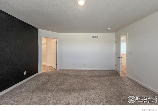 2325 Mountain Sky Dr, Fort Lupton, CO 80621 - carpeted empty room featuring baseboards, a textured ceiling, and a smoke detector