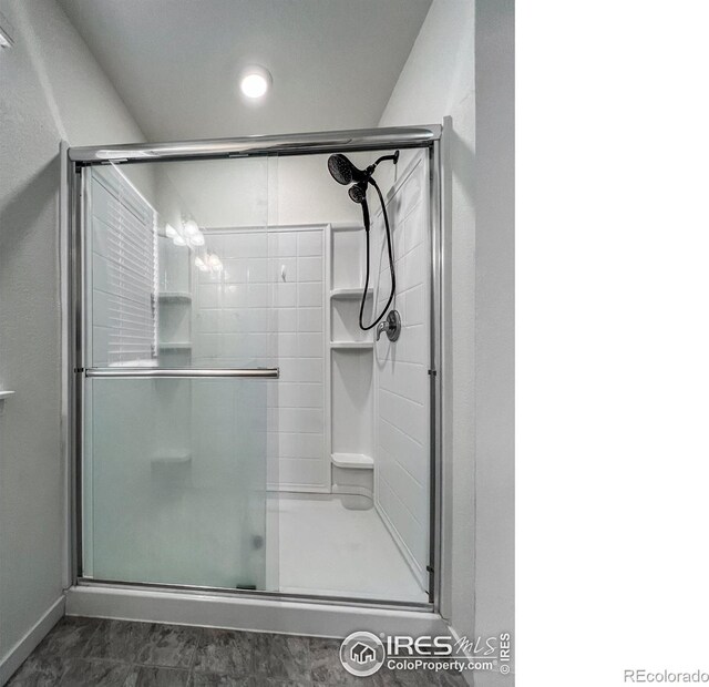 2325 Mountain Sky Dr, Fort Lupton, CO 80621 - full bathroom featuring a shower stall and marble look tiles