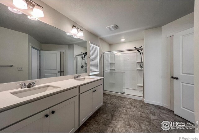 2325 Mountain Sky Dr, Fort Lupton, CO 80621 - bathroom with a stall shower and double vanity