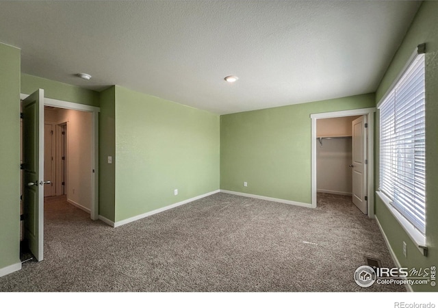2325 Mountain Sky Dr, Fort Lupton, CO 80621 - unfurnished bedroom featuring carpet, baseboards, and a spacious closet