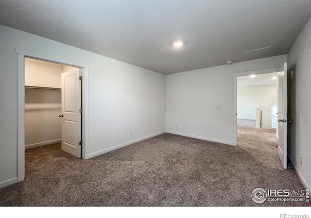 2325 Mountain Sky Dr, Fort Lupton, CO 80621 - unfurnished bedroom featuring carpet flooring, a spacious closet, baseboards, and recessed lighting