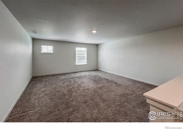 2325 Mountain Sky Dr, Fort Lupton, CO 80621 - carpeted spare room with baseboards and a textured ceiling