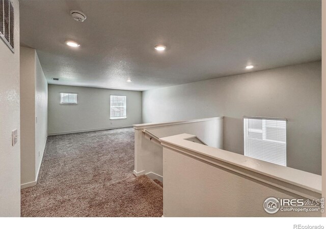 2325 Mountain Sky Dr, Fort Lupton, CO 80621 - hallway featuring an upstairs landing, carpet floors, recessed lighting, and baseboards