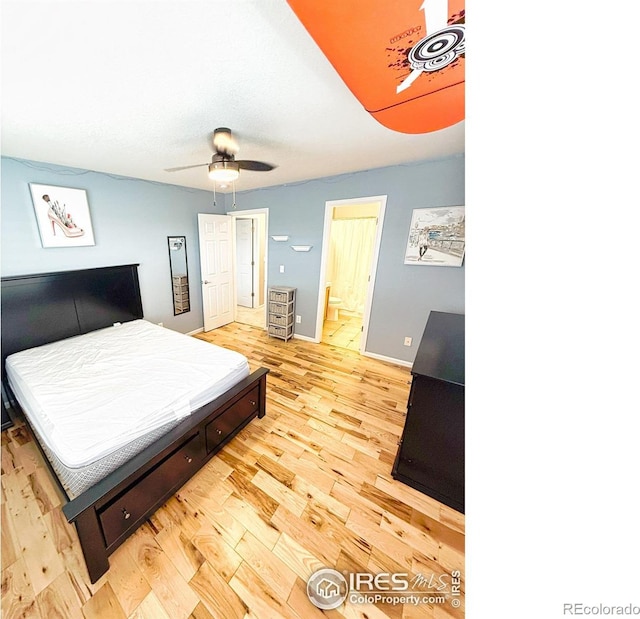 bedroom featuring connected bathroom, a ceiling fan, baseboards, and light wood-style floors