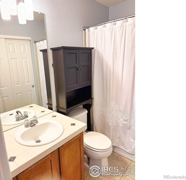 bathroom featuring vanity, tile patterned flooring, a shower with curtain, and toilet