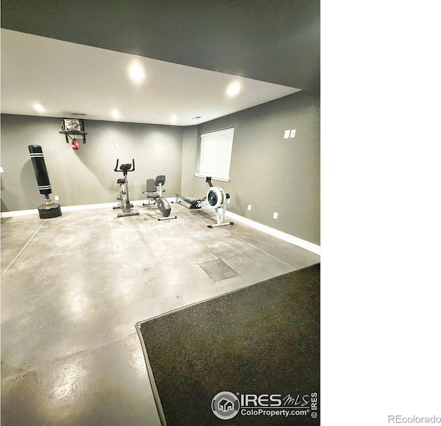 exercise room with recessed lighting and baseboards