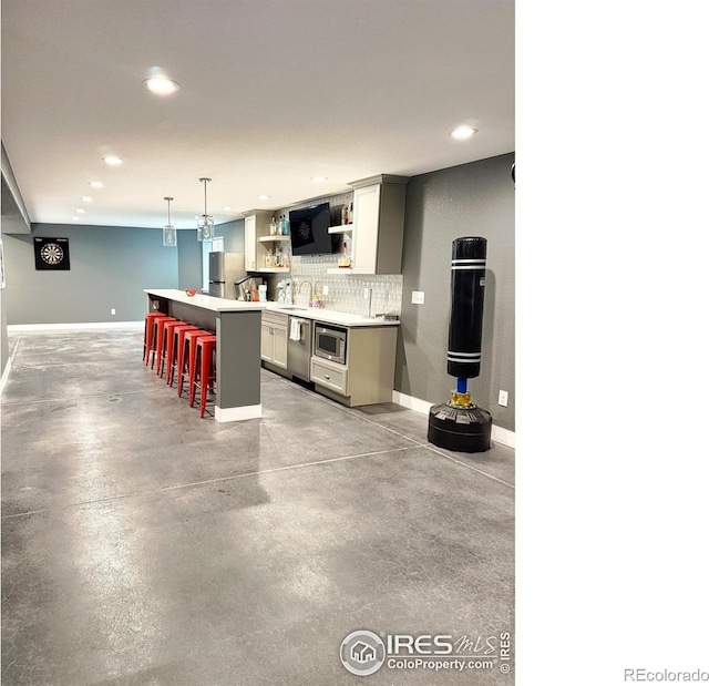 kitchen featuring a kitchen breakfast bar, finished concrete floors, open shelves, baseboards, and recessed lighting