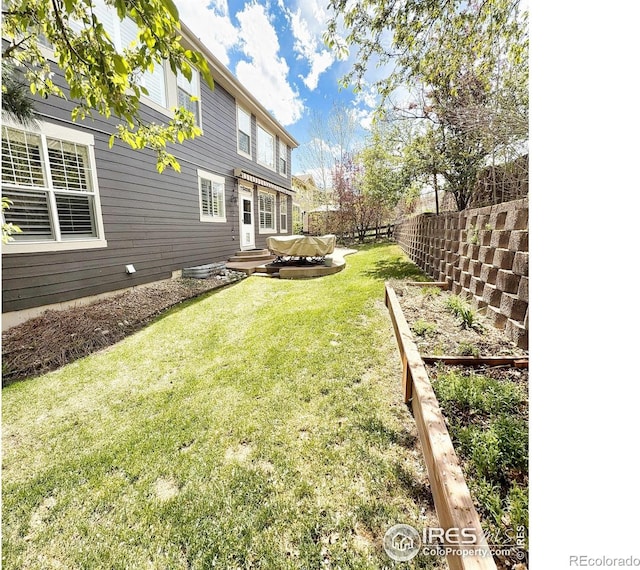 view of yard featuring fence and a garden