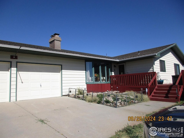 13969 County Road 33, Sterling, CO 80751 - single story home with a chimney, an attached garage, and driveway
