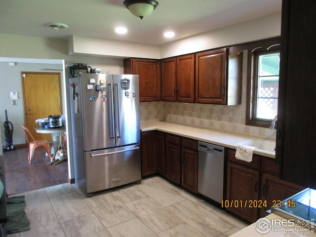 13969 County Road 33, Sterling, CO 80751 - kitchen with a sink, light countertops, marble finish floor, stainless steel appliances, and tasteful backsplash