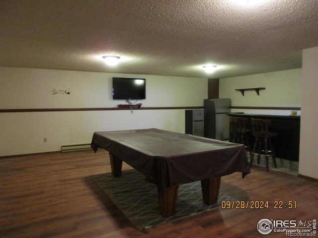 13969 County Road 33, Sterling, CO 80751 - rec room featuring a dry bar, a baseboard heating unit, a textured ceiling, and wood finished floors